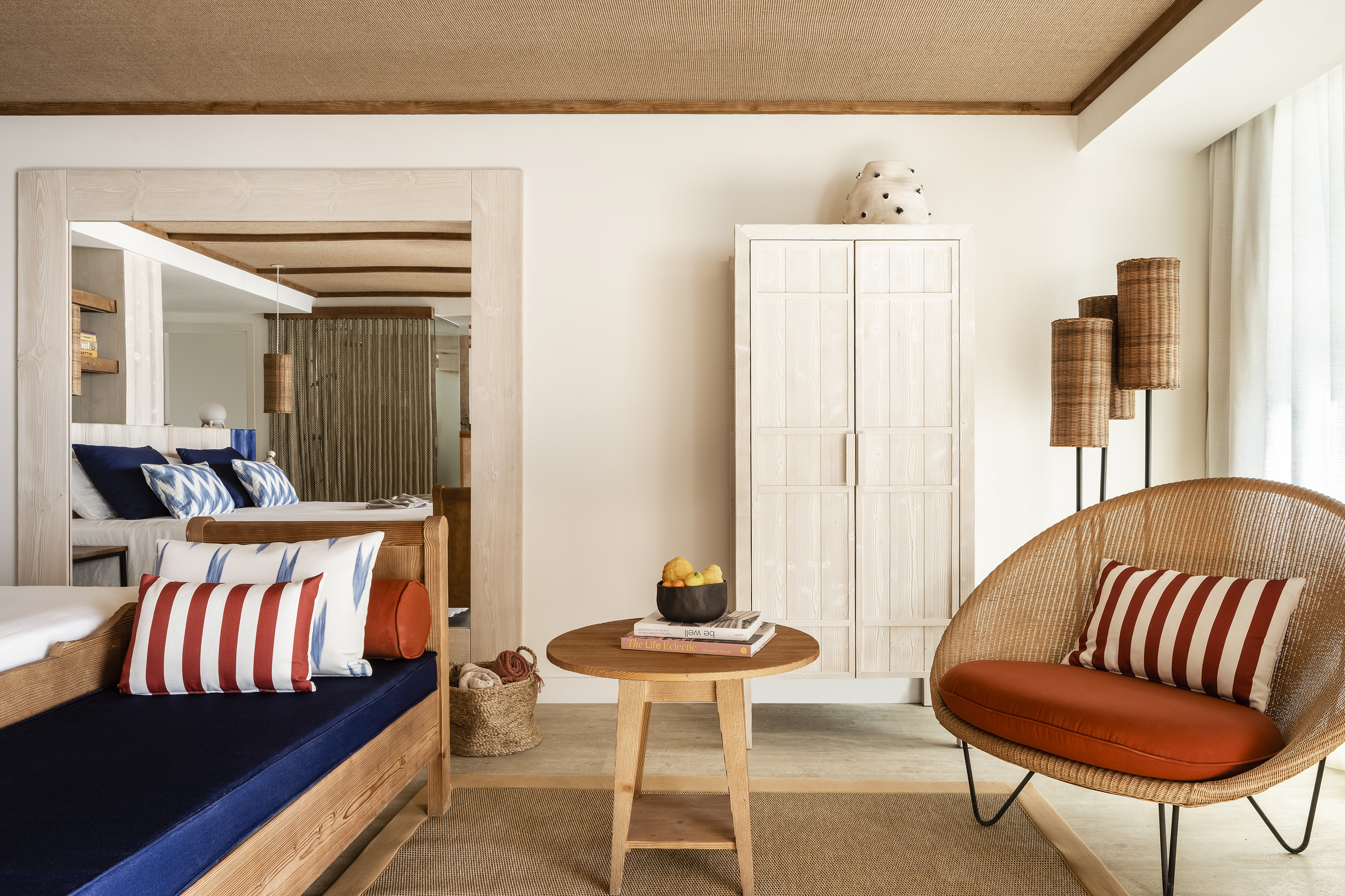 Tropical suite with wicker chair, wooden daybed, and natural wood accents.