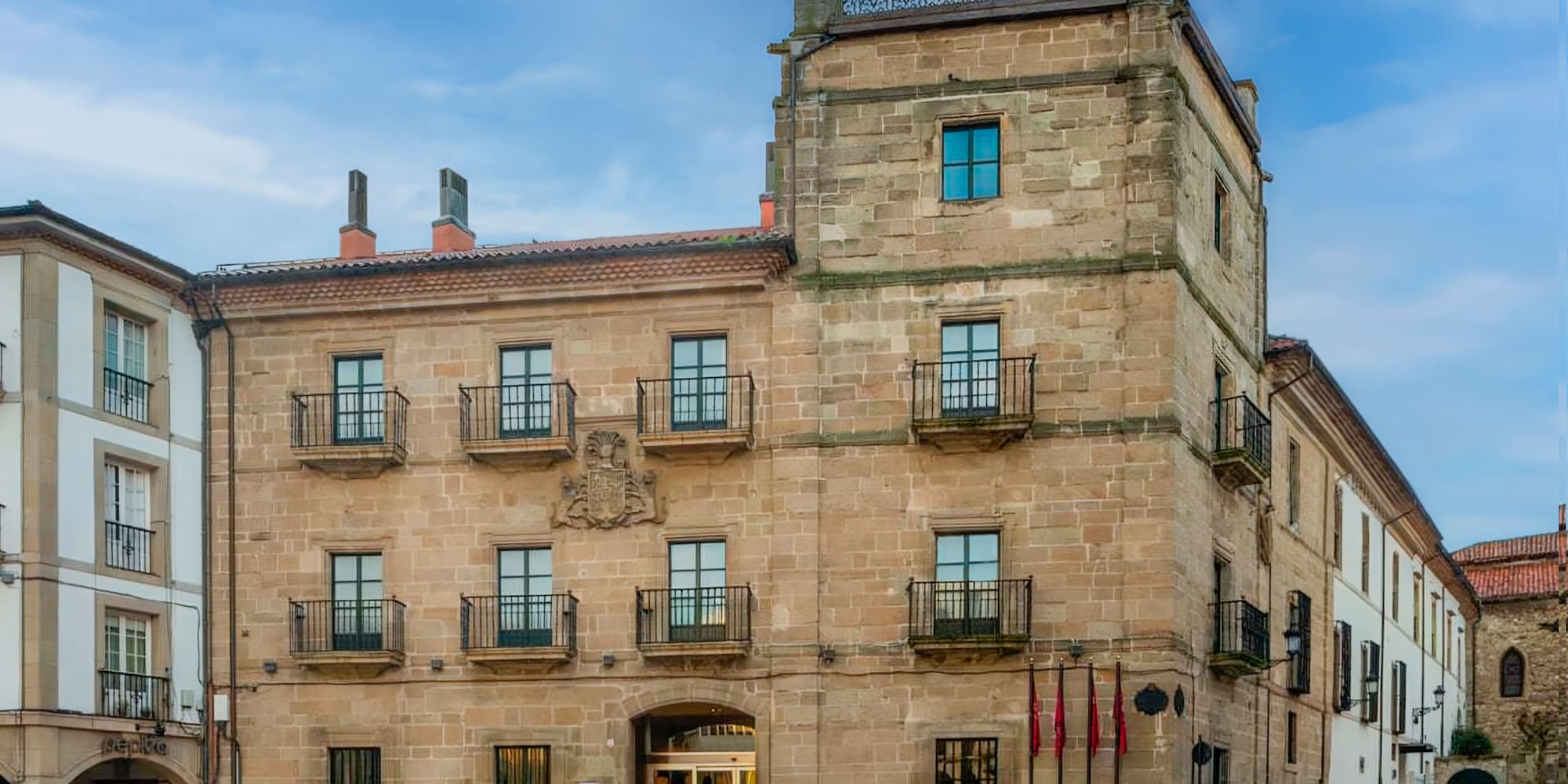 a building with a stone wall and a stone walkway