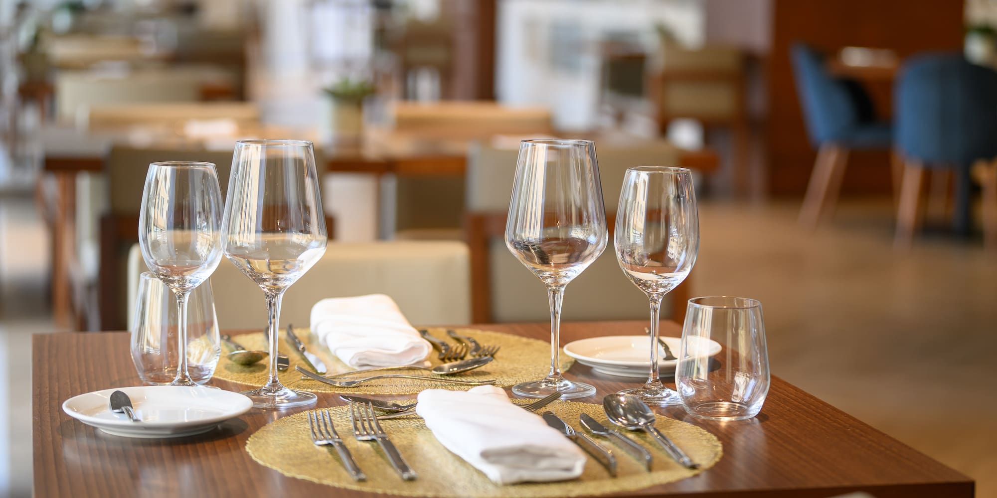 a table with glasses and plates