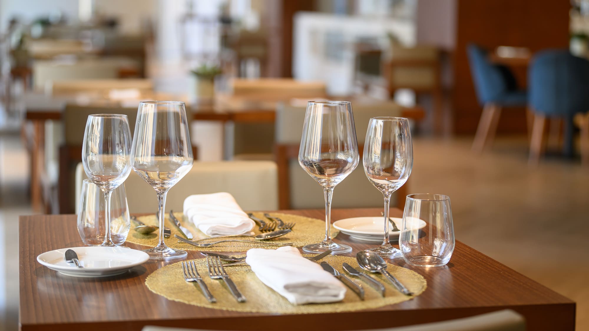 a table with glasses and plates