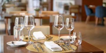 a table with glasses and plates