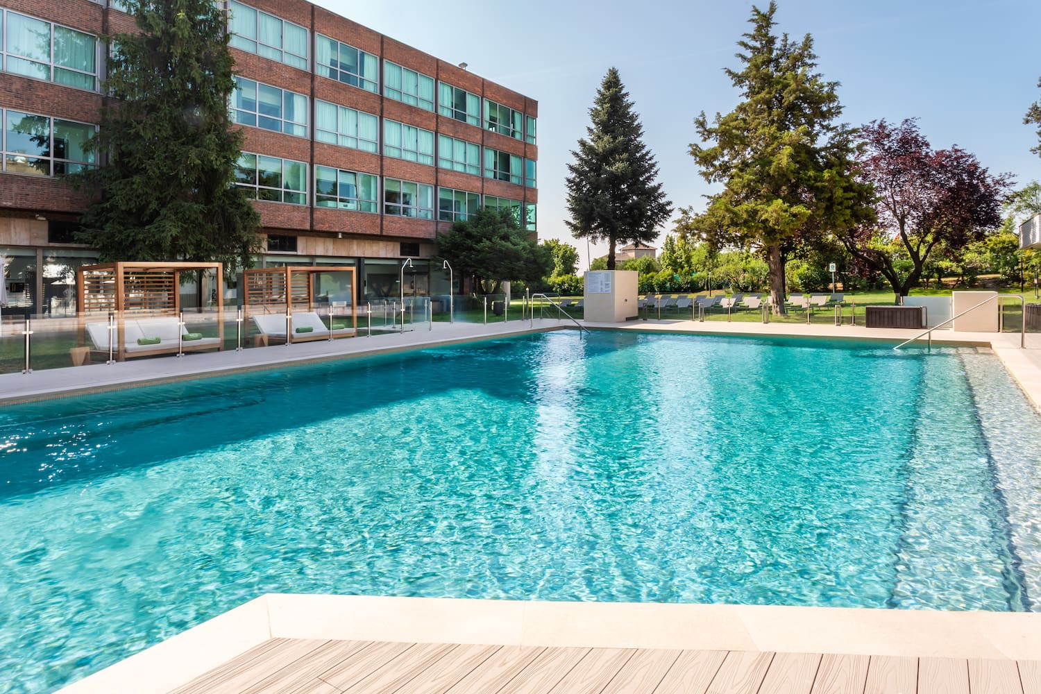 a pool with trees and buildings in the background