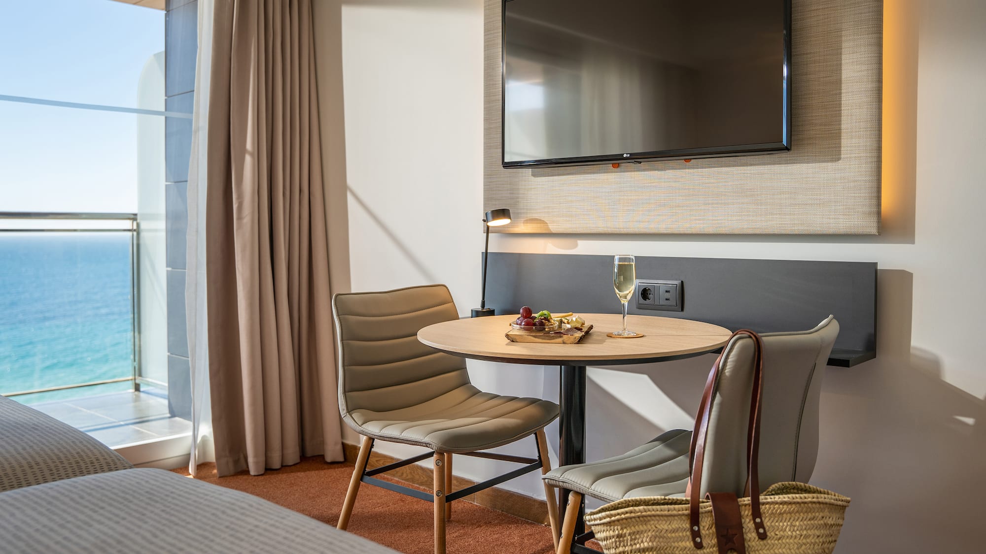 a room with a table and chairs and a television