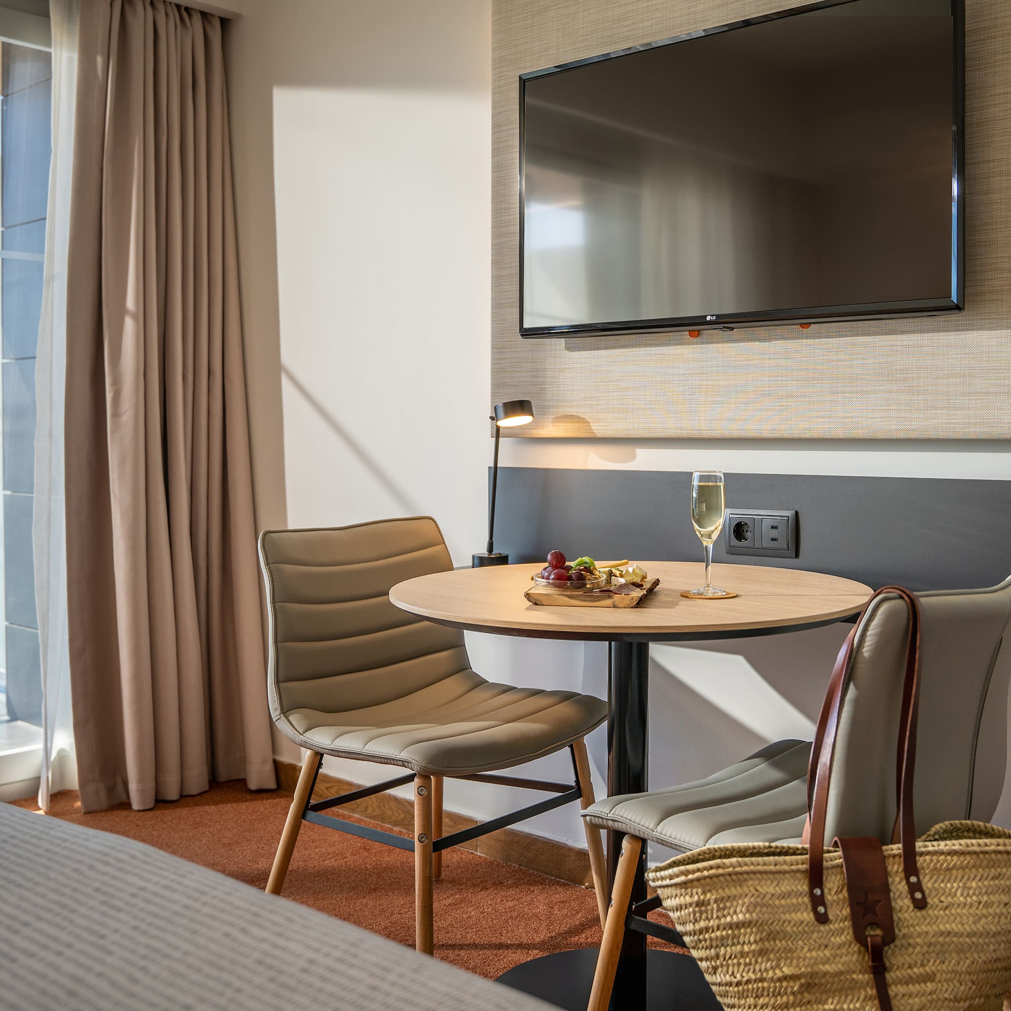 a room with a table and chairs and a television