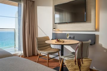 a room with a table and chairs and a television