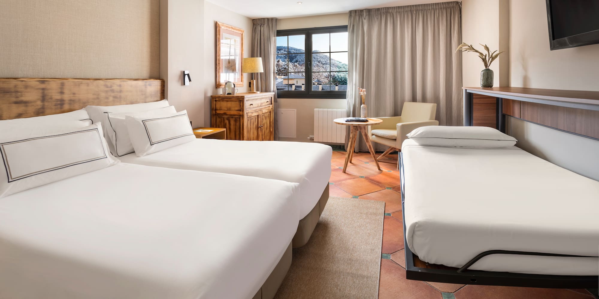 a room with two beds and a table