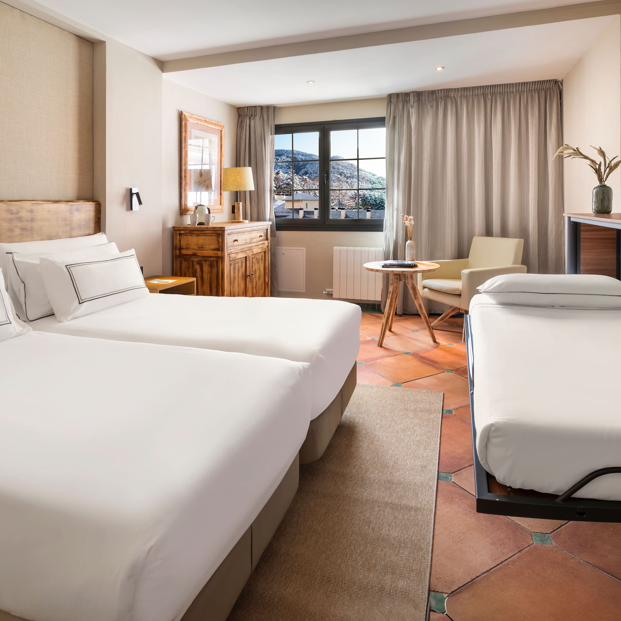 a room with two beds and a table