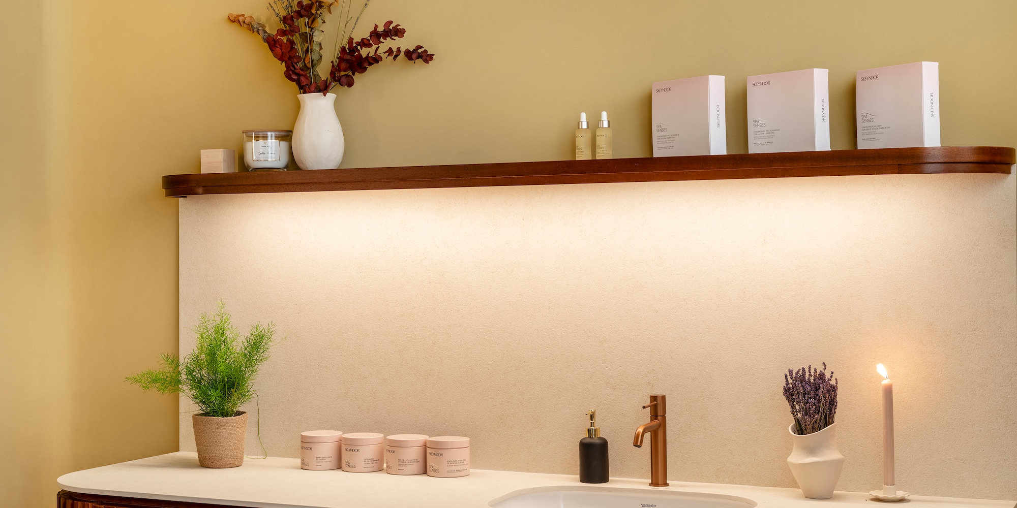 a bathroom with a sink and candles