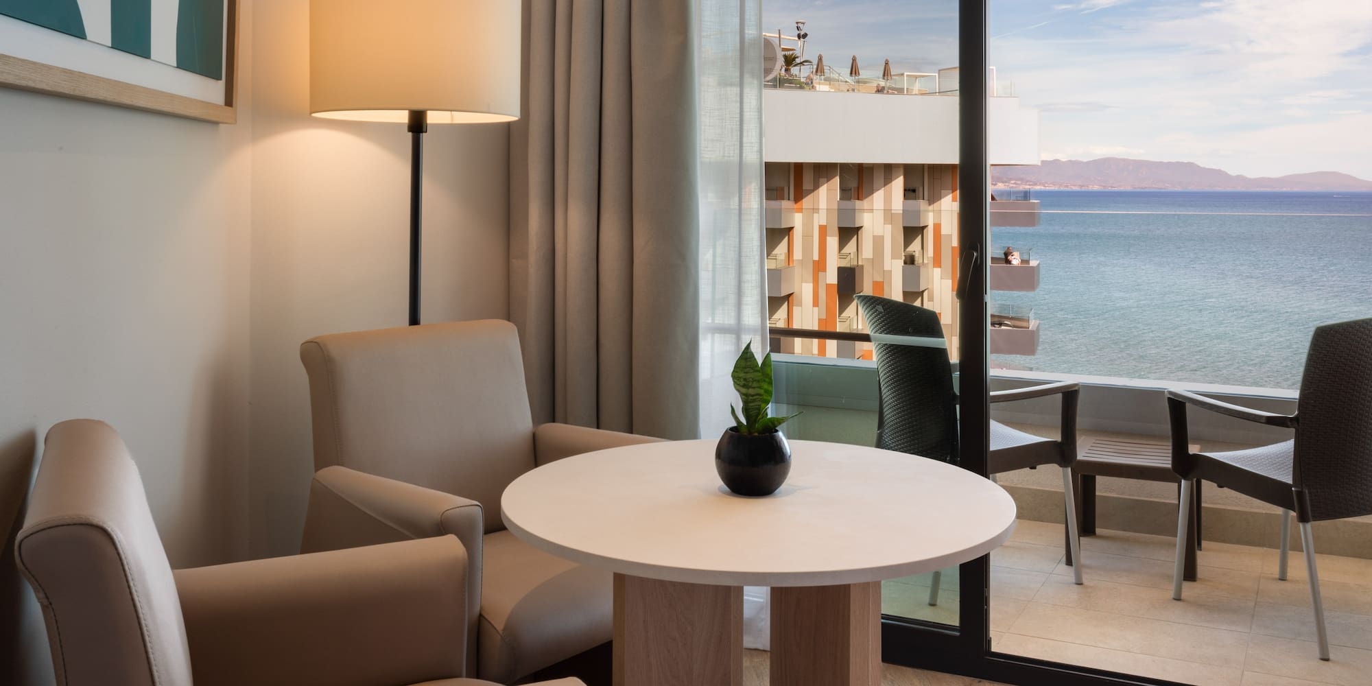 a room with a table and chairs and a lamp