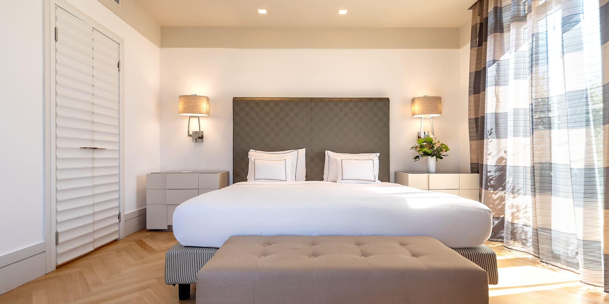 a bedroom with a bed and a bench