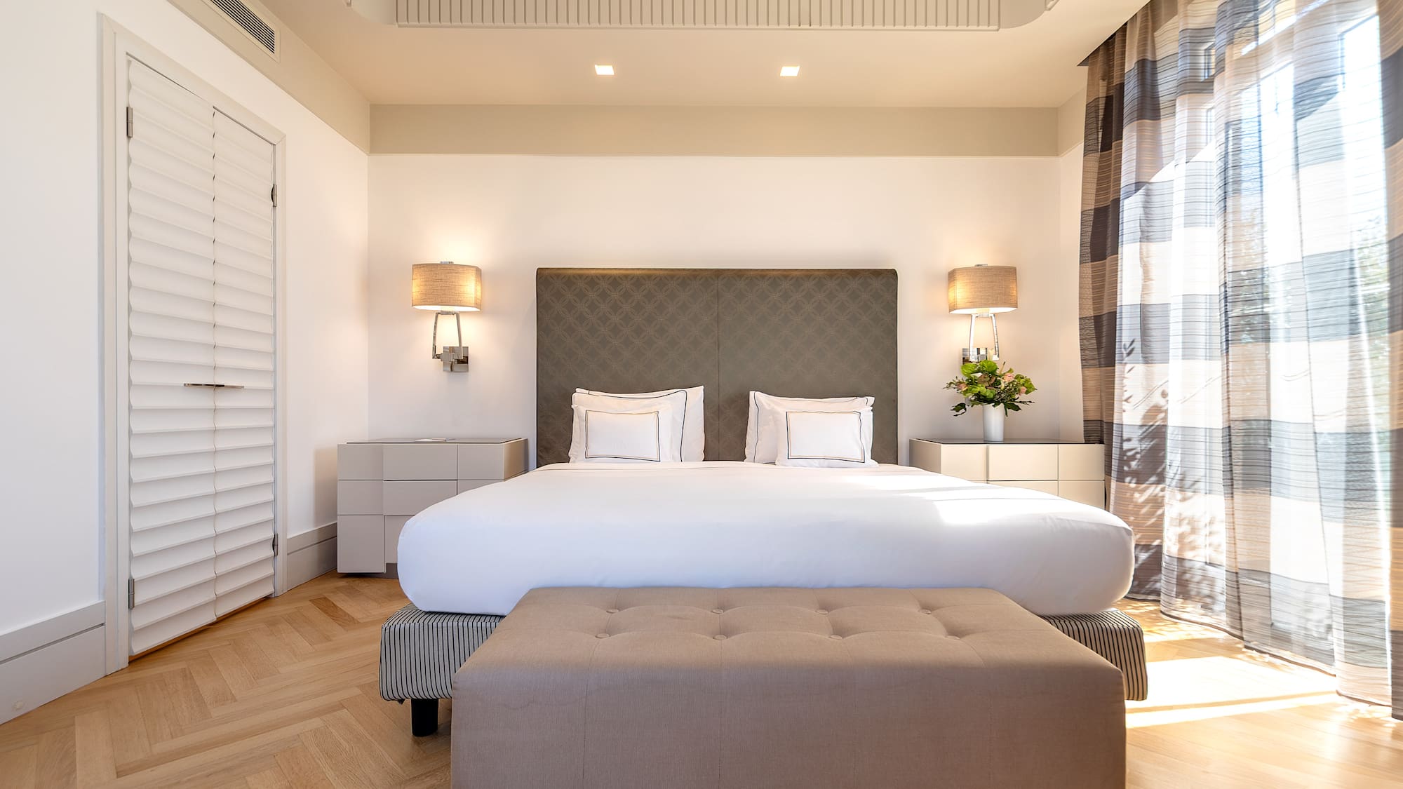 a bedroom with a bed and a bench