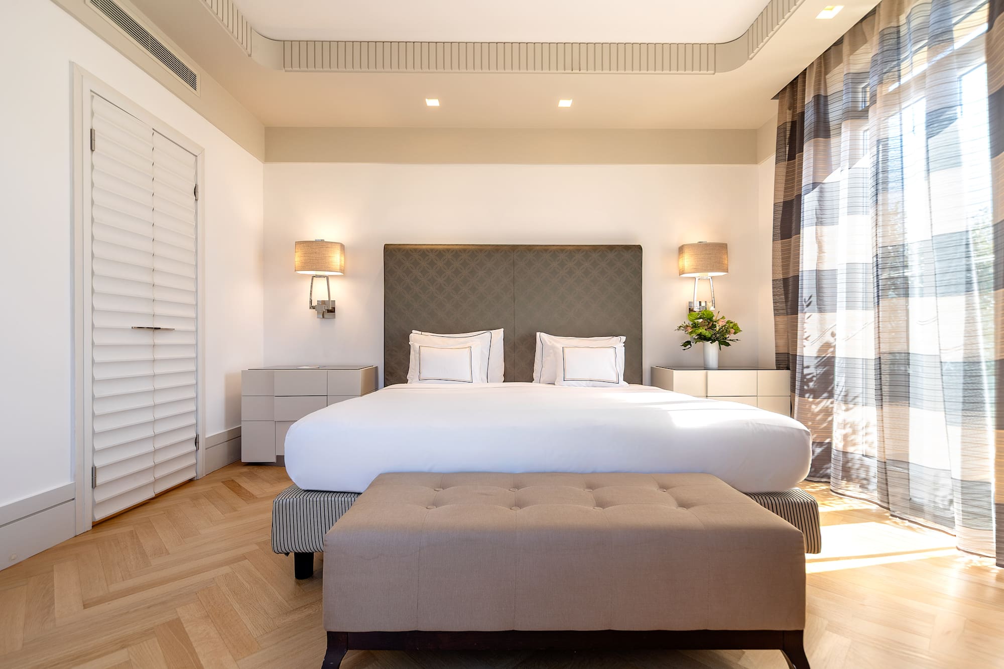 a bedroom with a bed and a bench