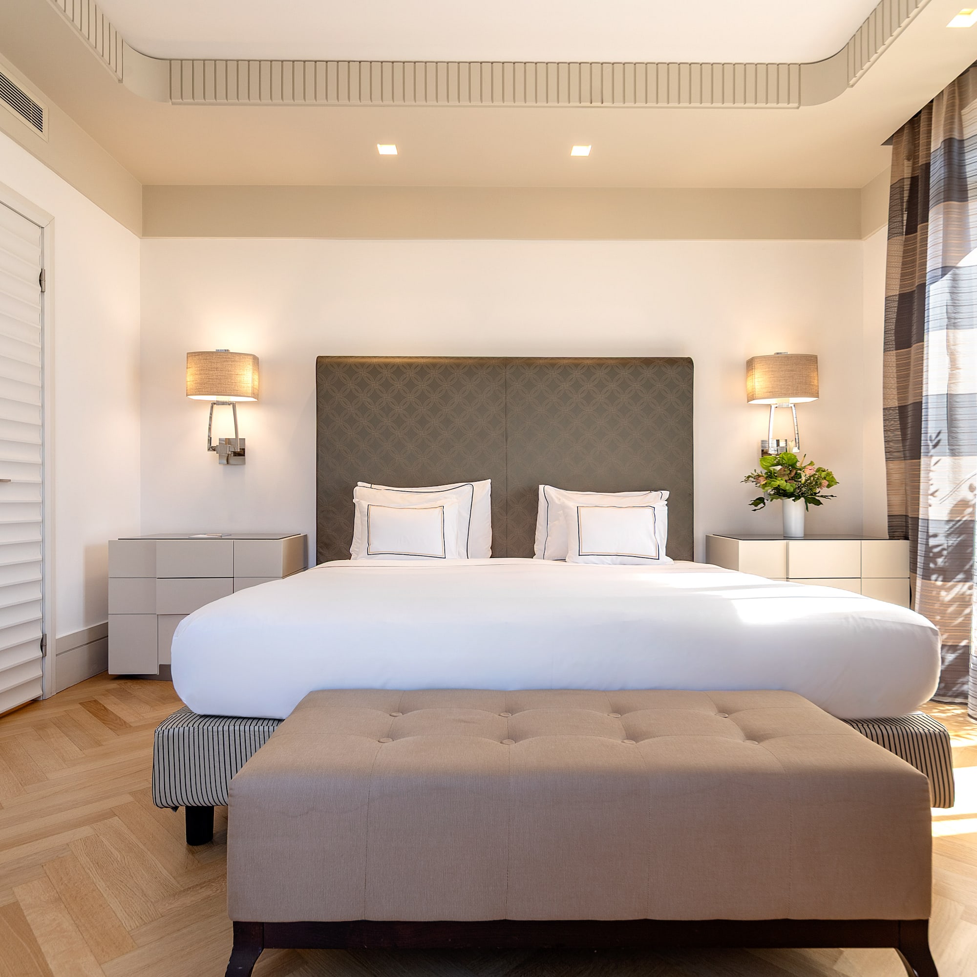 a bedroom with a bed and a bench