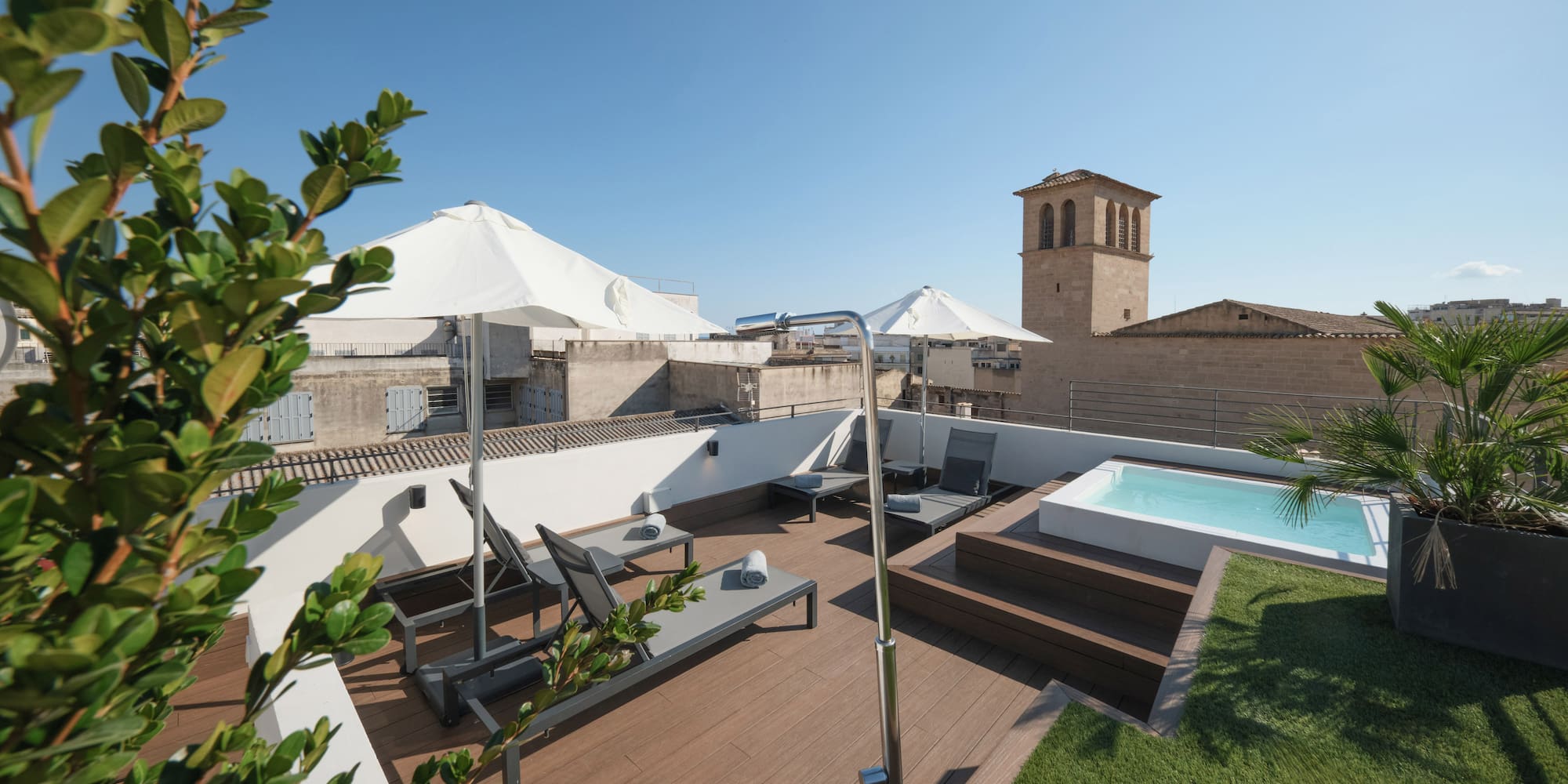 a deck with a pool and a deck chair on a rooftop