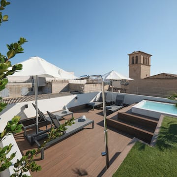 a deck with a pool and a deck chair on a rooftop