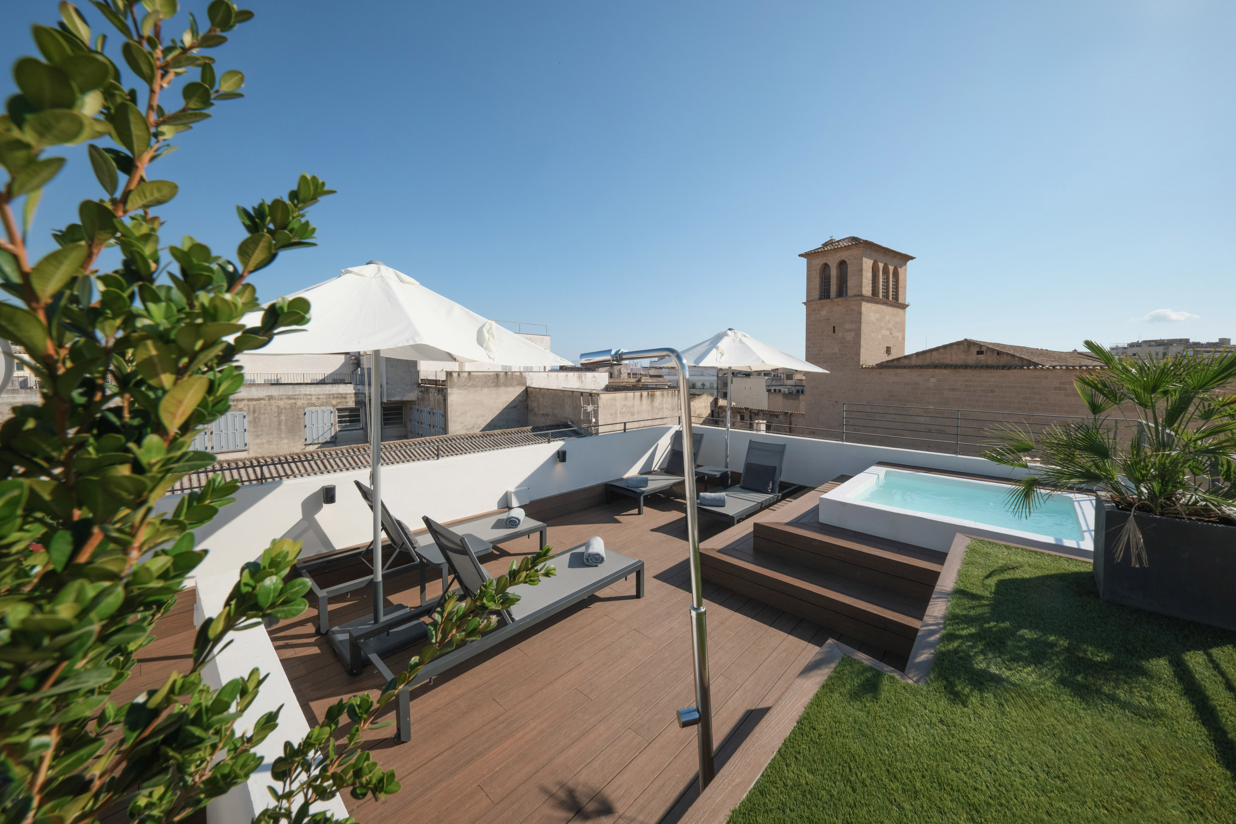 a deck with a pool and a deck chair on a rooftop