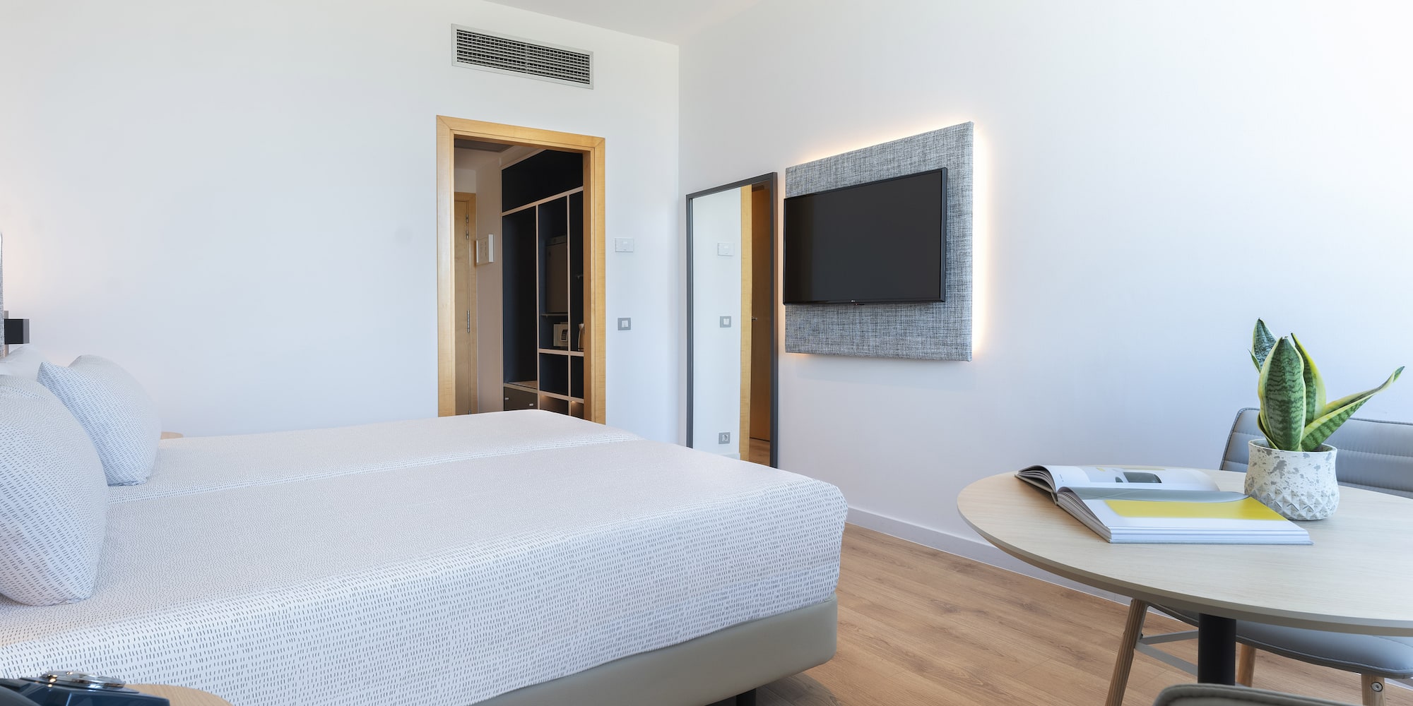 a room with a bed and a tv