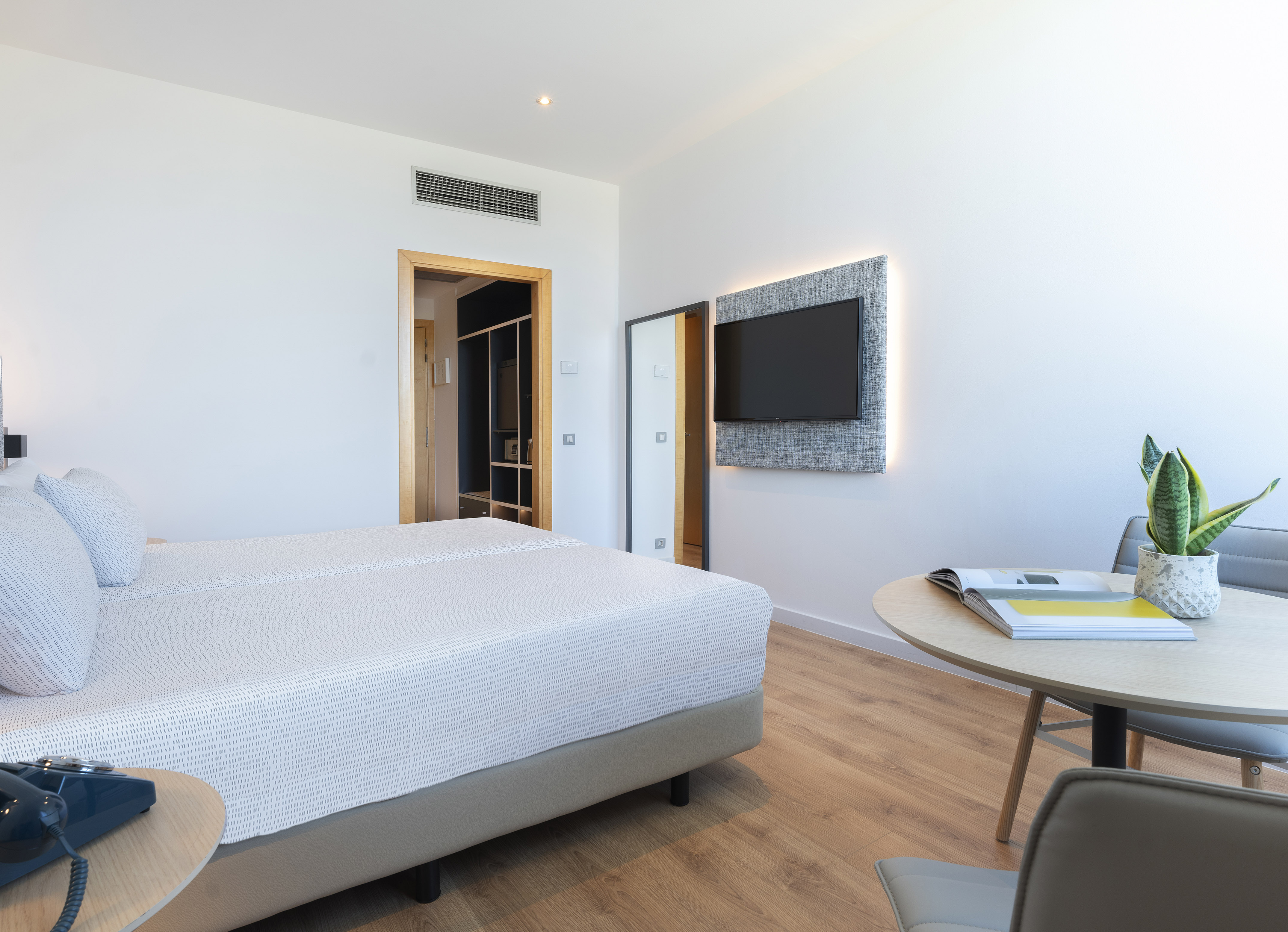 a room with a bed and a tv