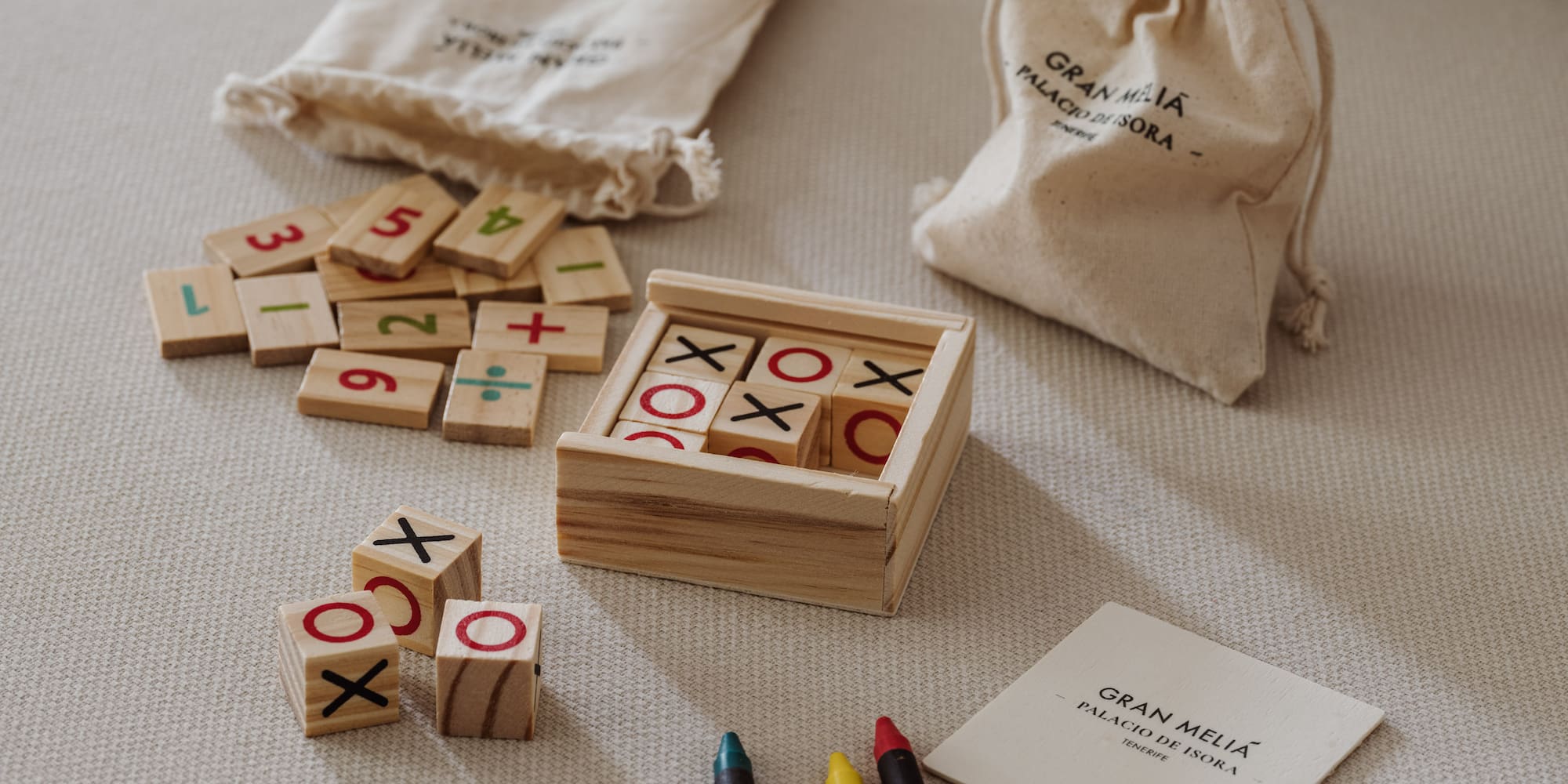 a wooden blocks with numbers and markers on a bed