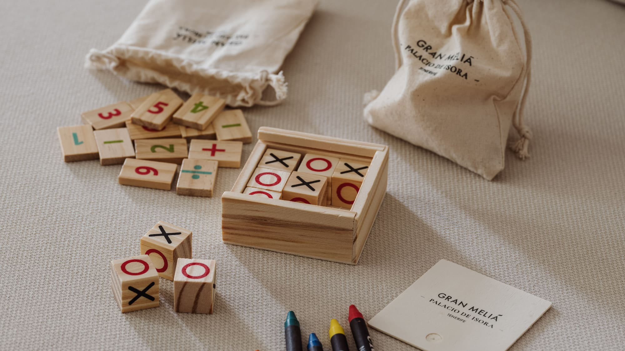 a wooden blocks with numbers and markers on a bed