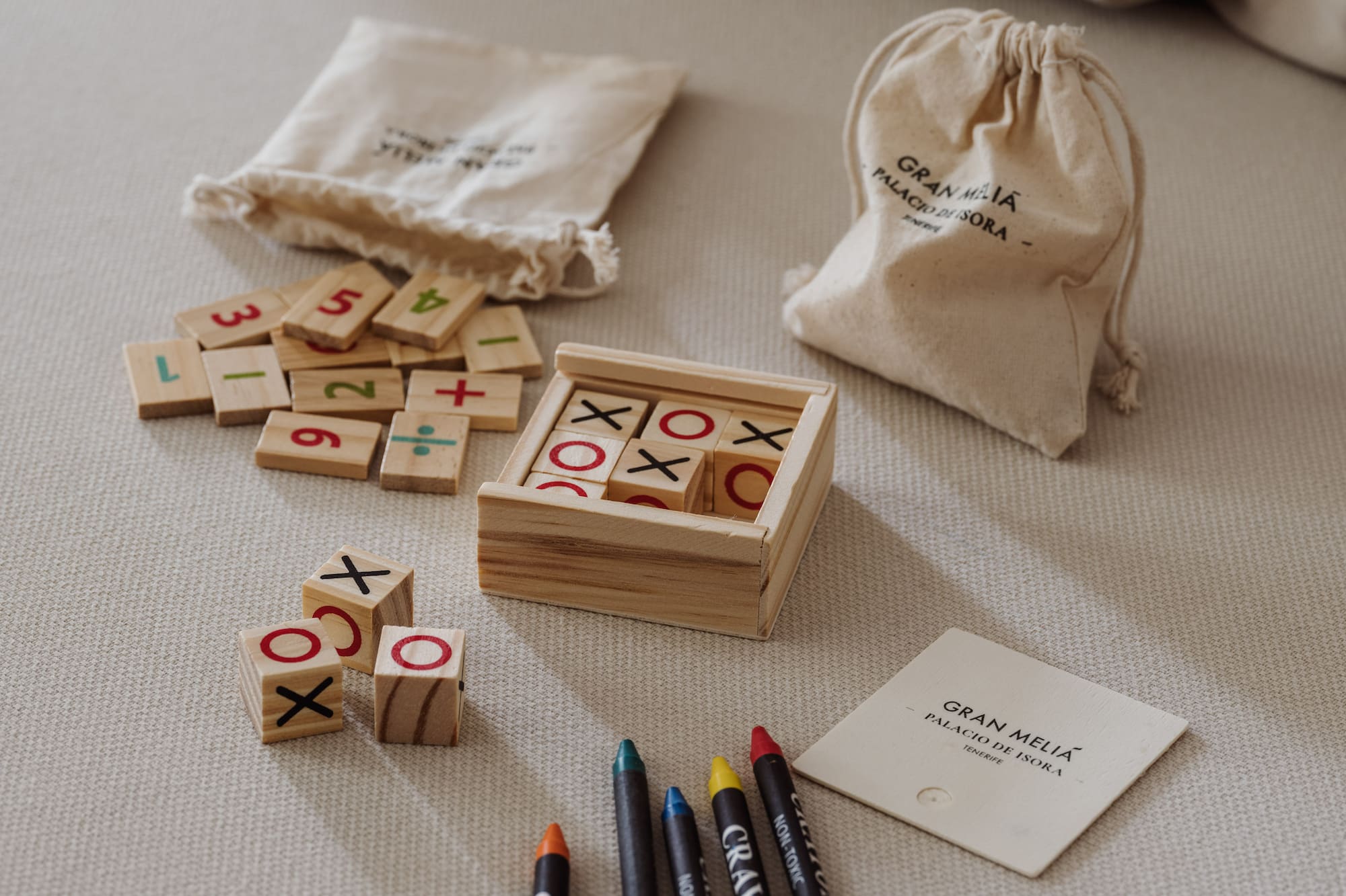 a wooden blocks with numbers and markers on a bed