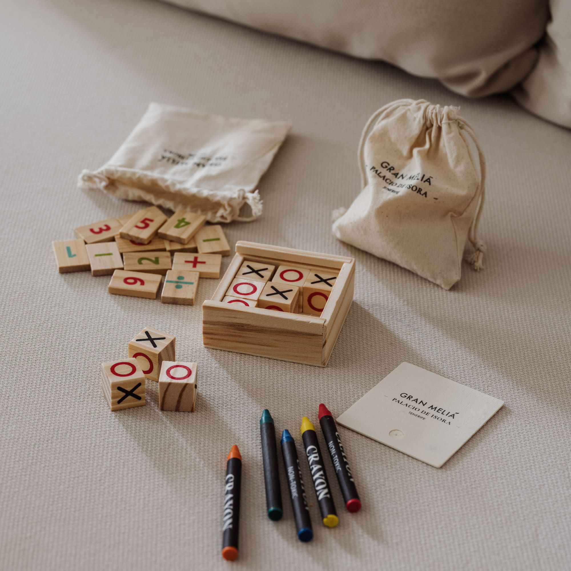 a wooden blocks with numbers and markers on a bed