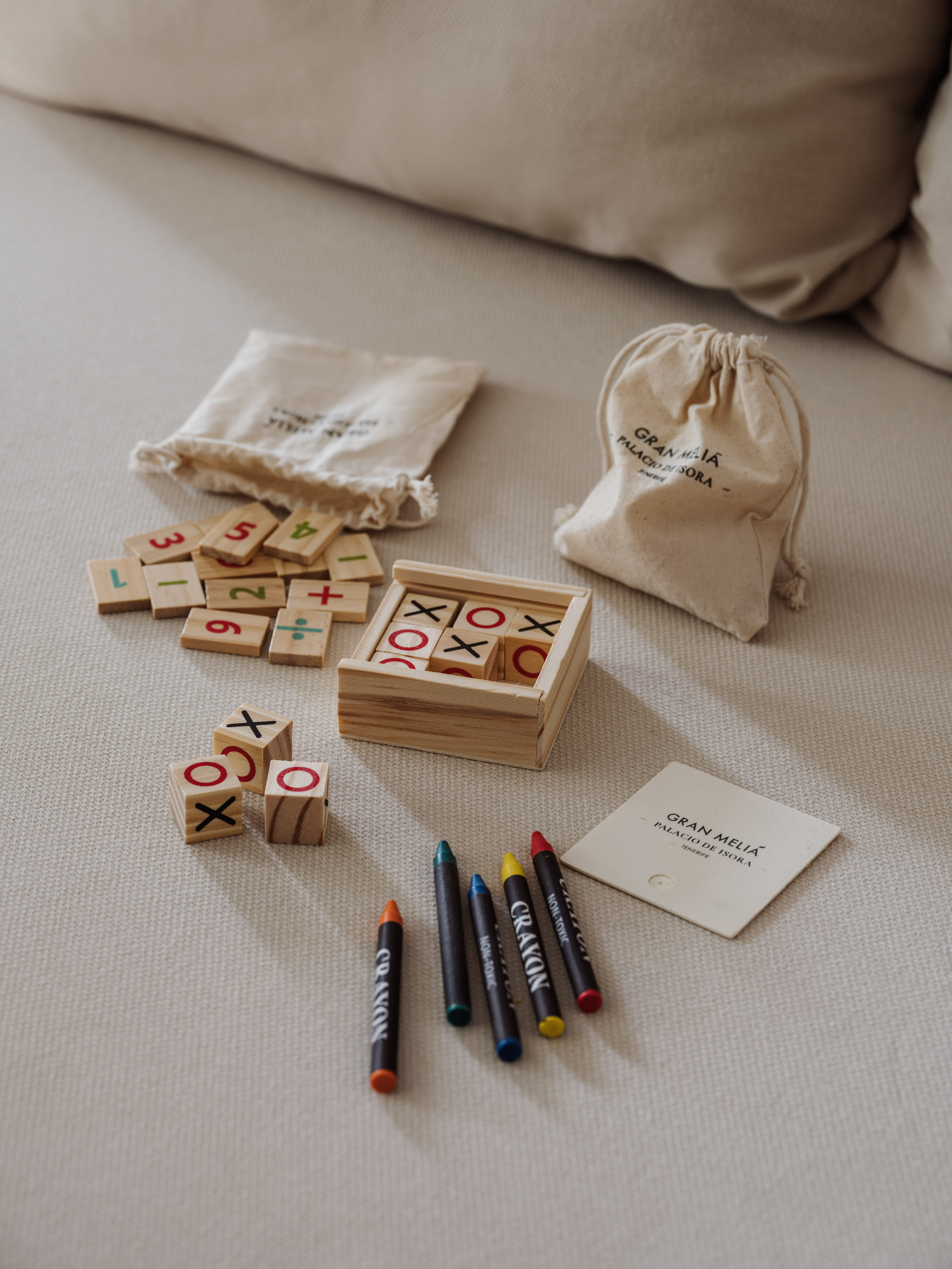 a wooden blocks with numbers and markers on a bed