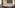 Luxurious hotel bedroom with large bed, padded headboard, and ambient lighting.