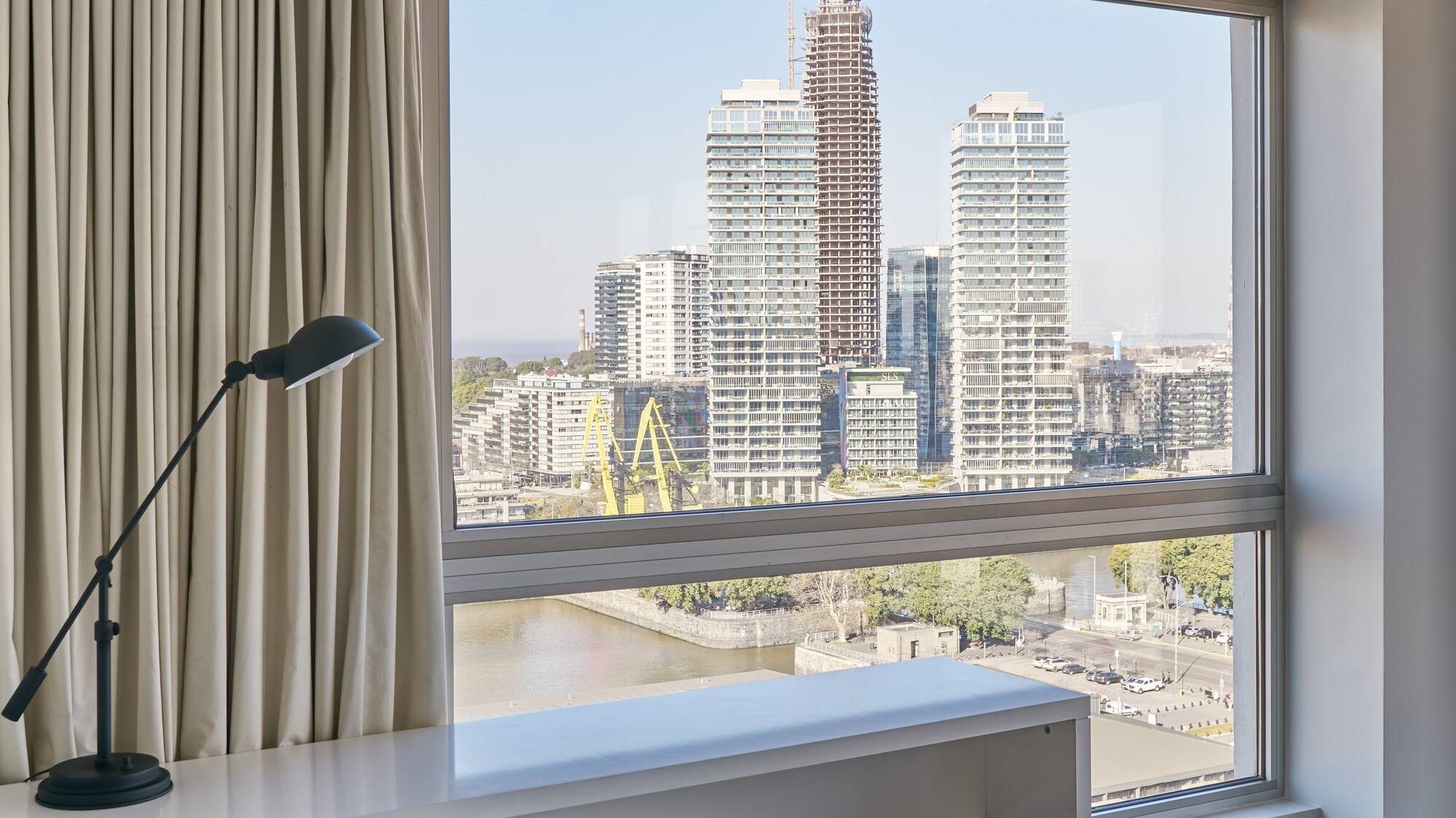 a desk and chair in a room with a large window
