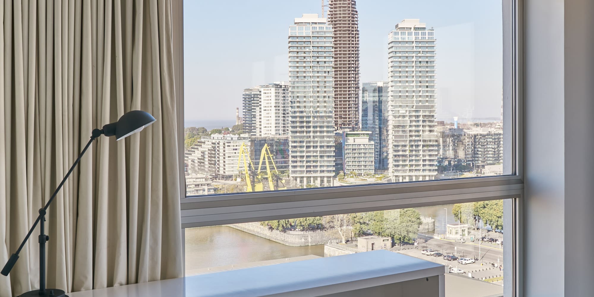 a desk and chair in a room with a large window