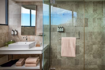 a bathroom with a glass shower door