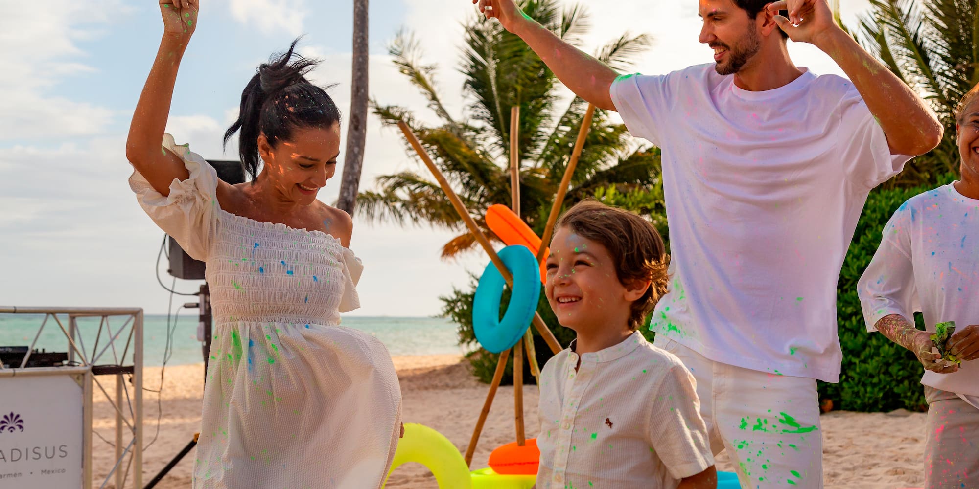 a man and woman with a child on a beach