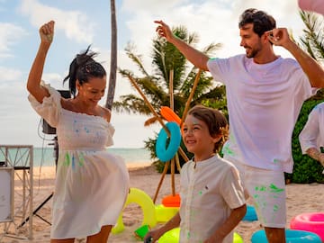 a man and woman with a child on a beach