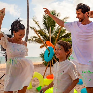 a man and woman with a child on a beach