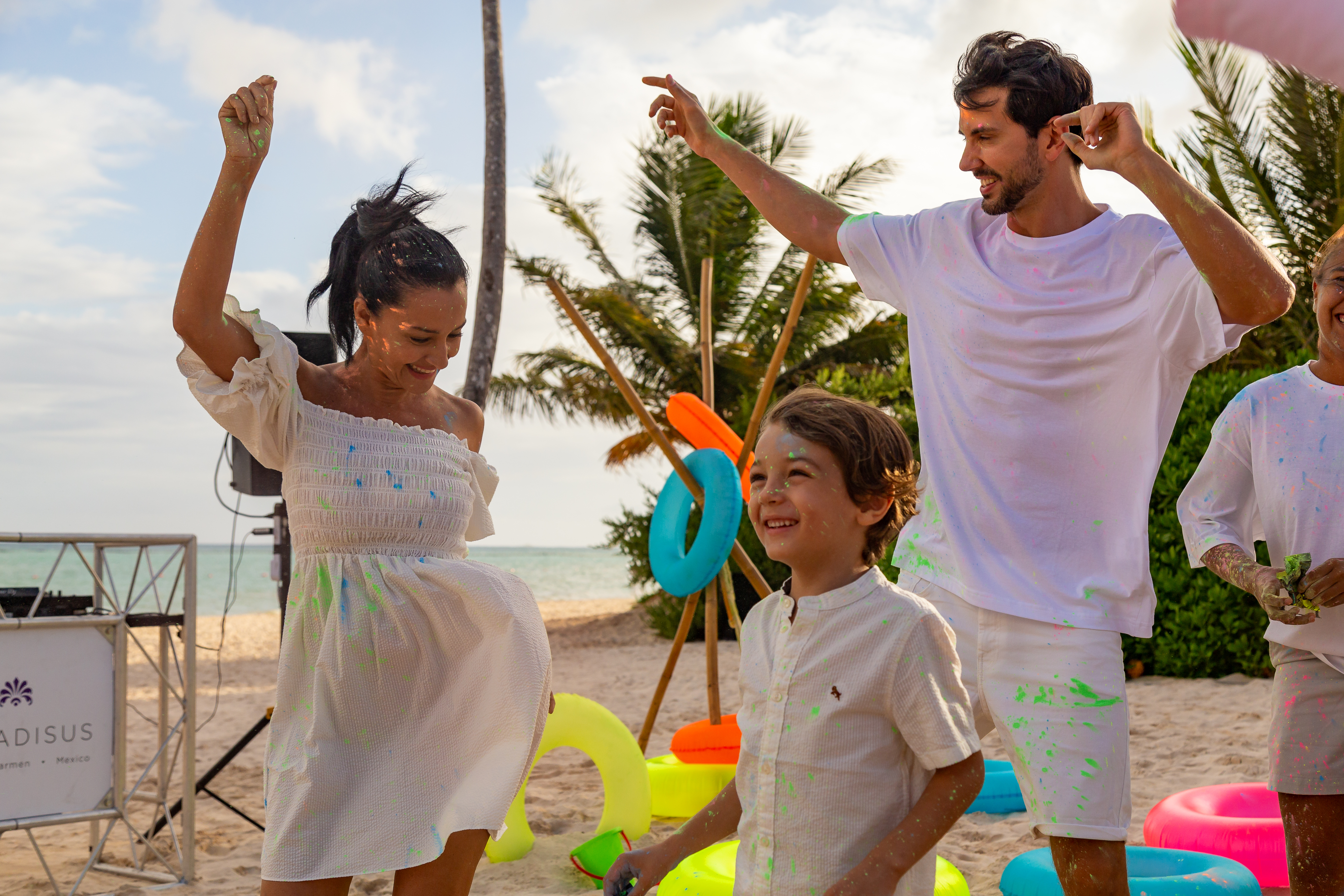 a man and woman with a child on a beach