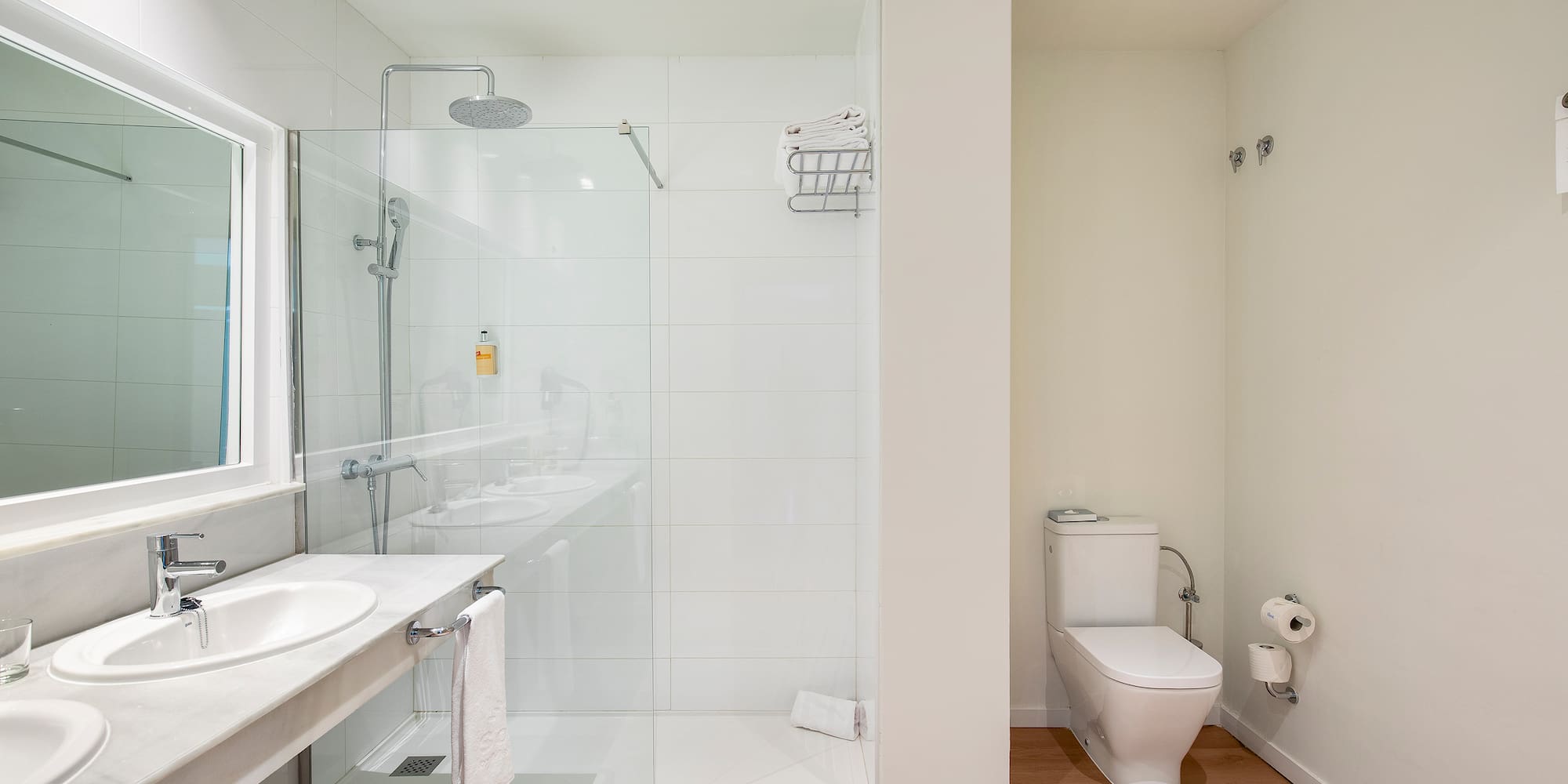 a bathroom with a glass shower and sink