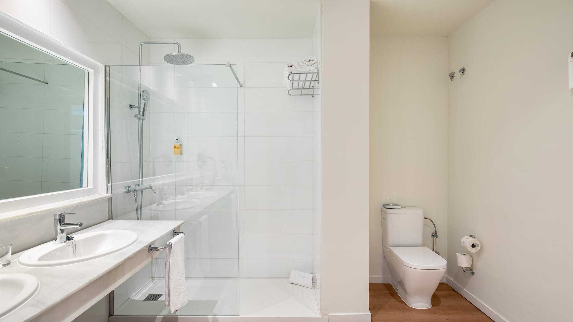 a bathroom with a glass shower and sink