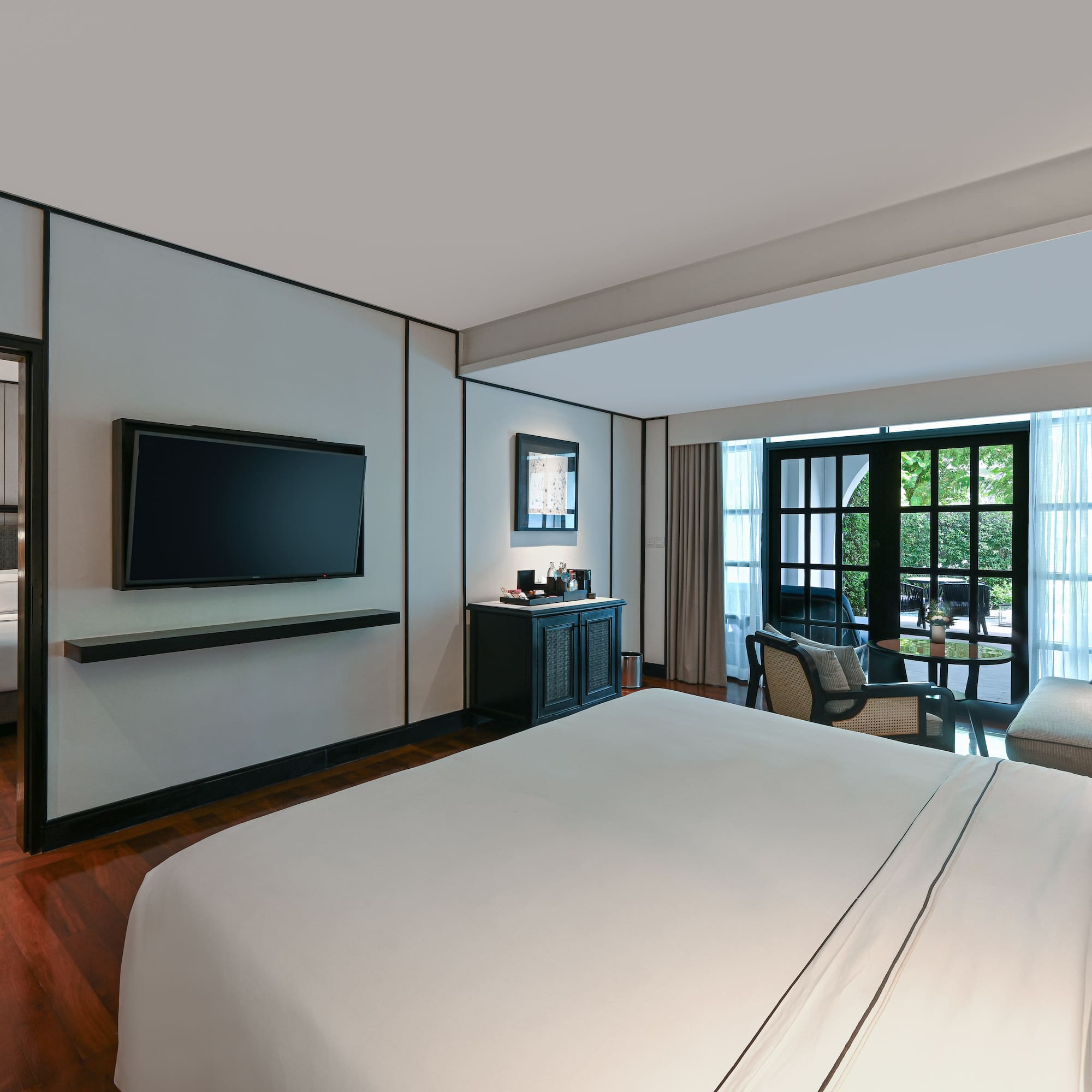 a room with a bed and a television