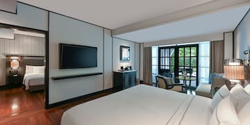 a room with a bed and a television