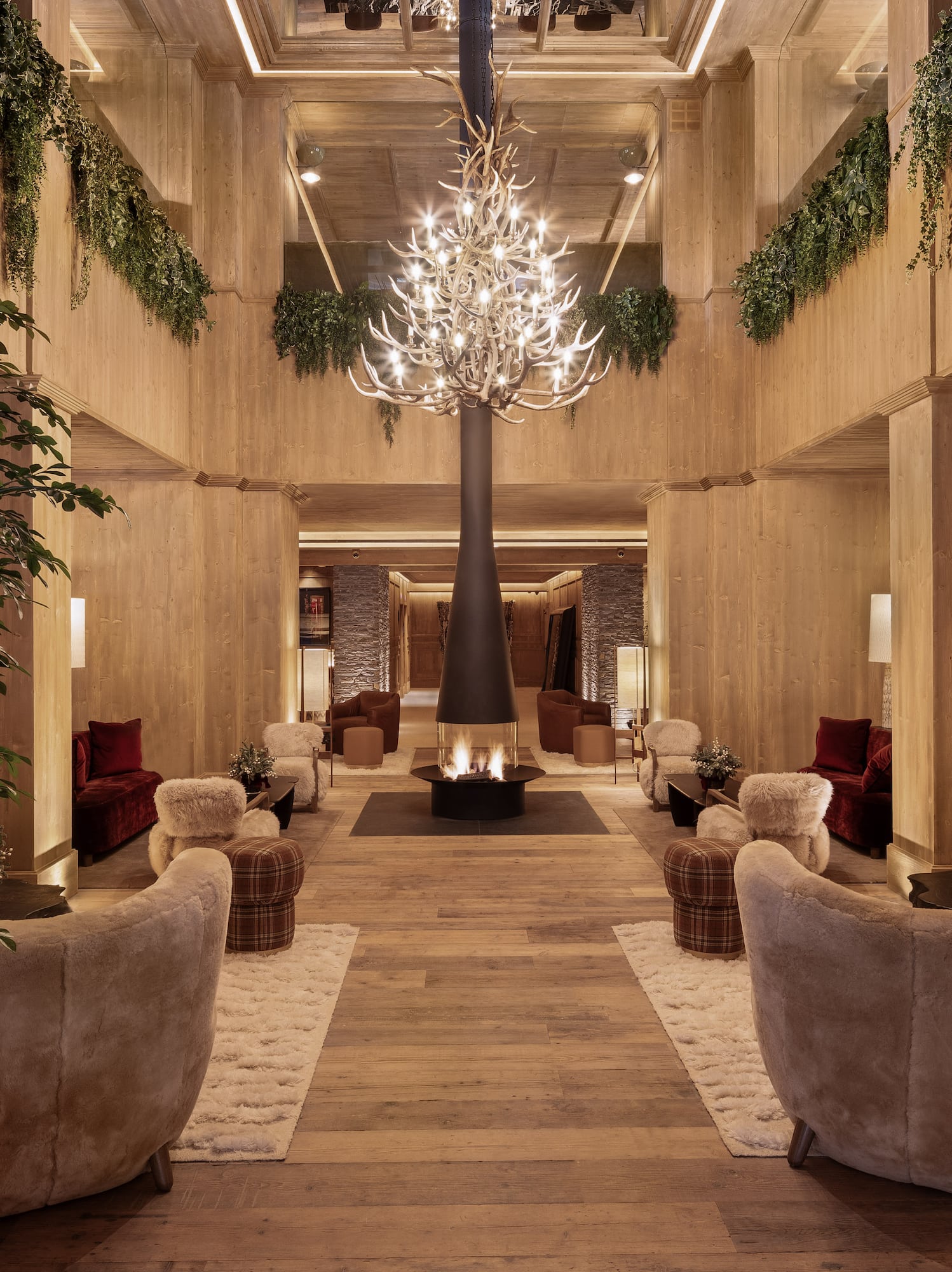 a room with a chandelier and a fire