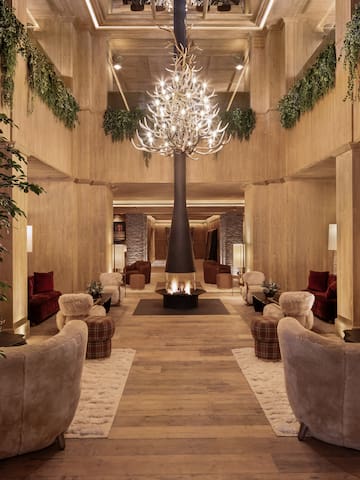 a room with a chandelier and a fire