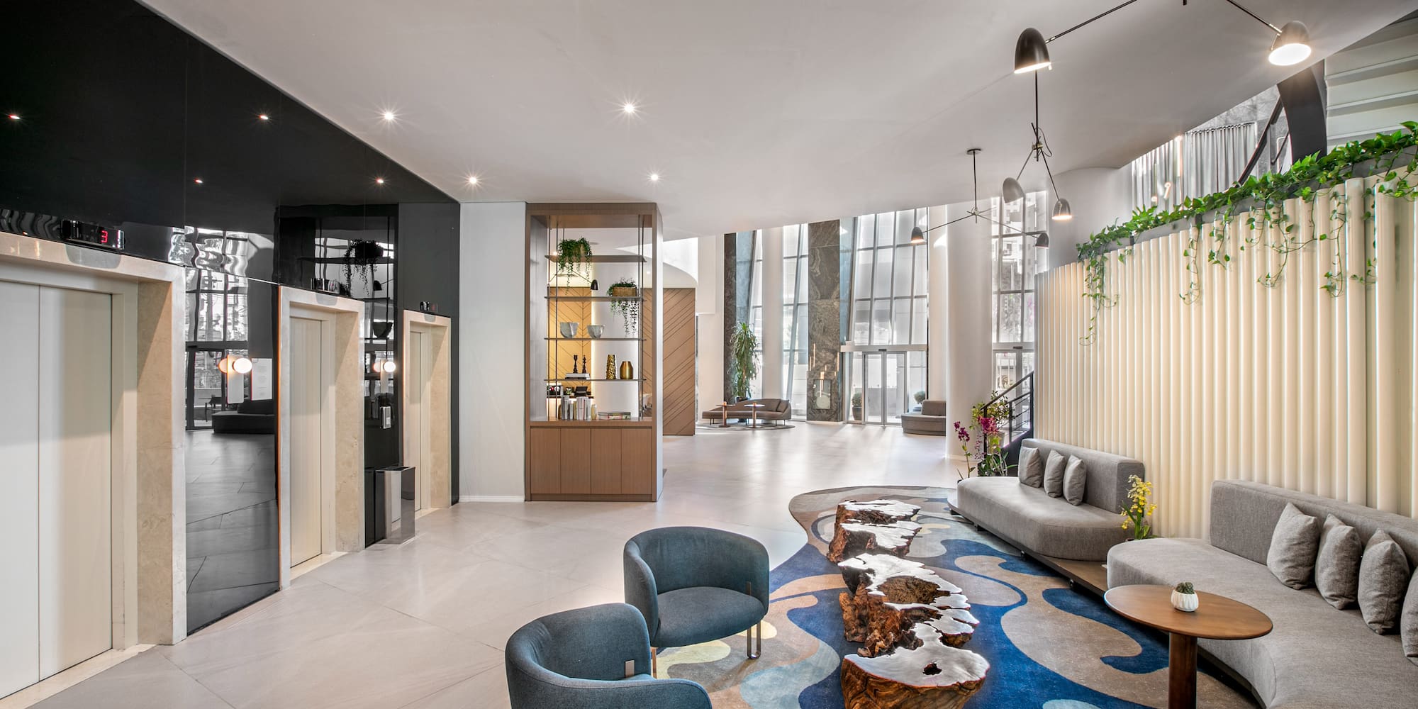 a room with a blue rug and chairs