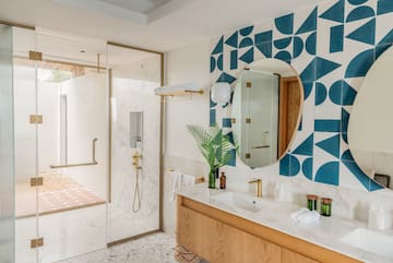a bathroom with a shower and a mirror