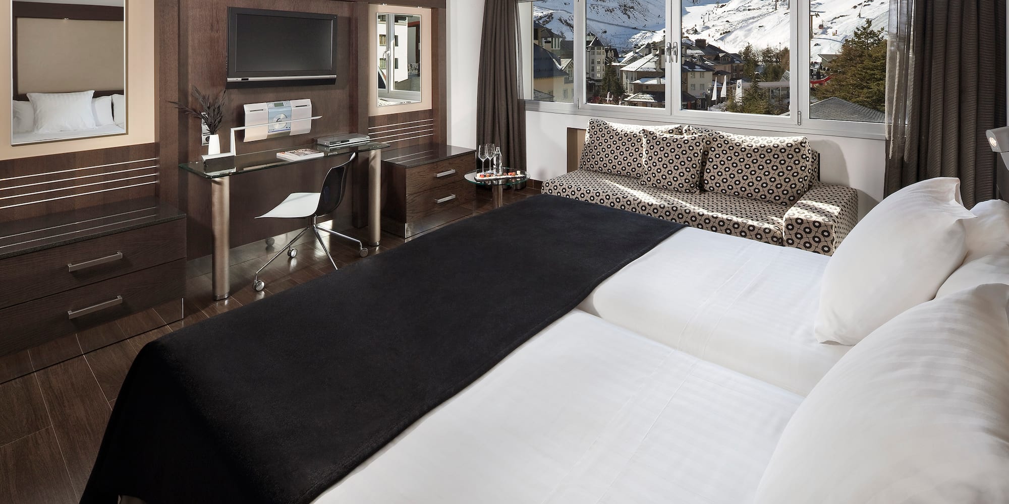 a room with two beds and a desk