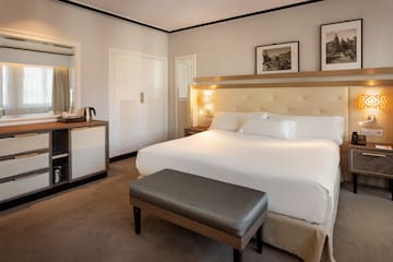 a bedroom with a bed and a mirror