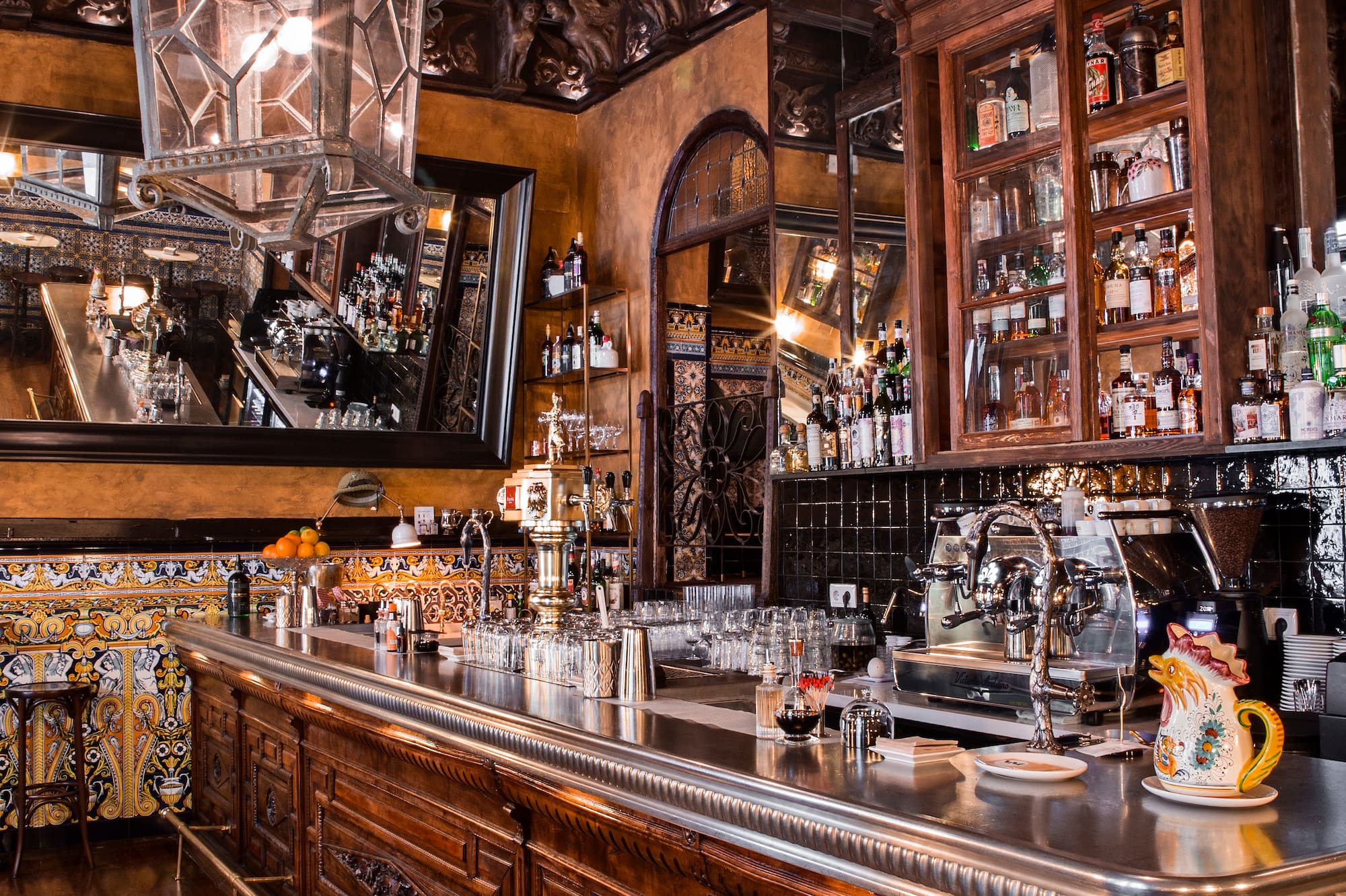 a bar with a mirror and bottles