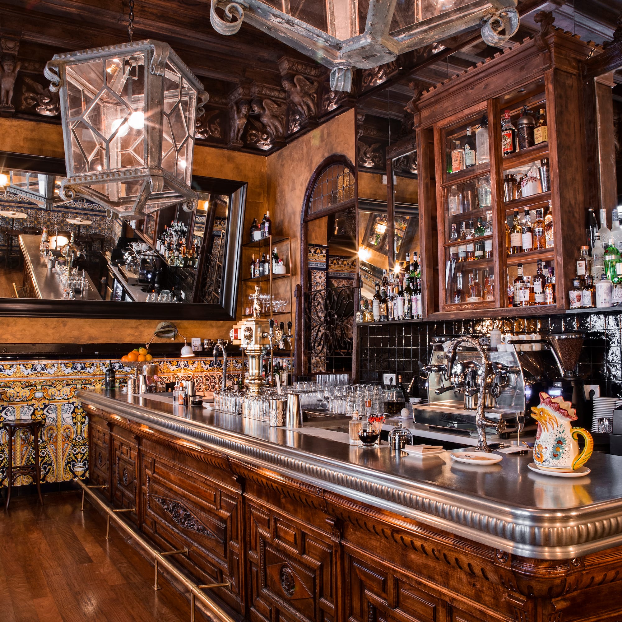 a bar with a mirror and bottles