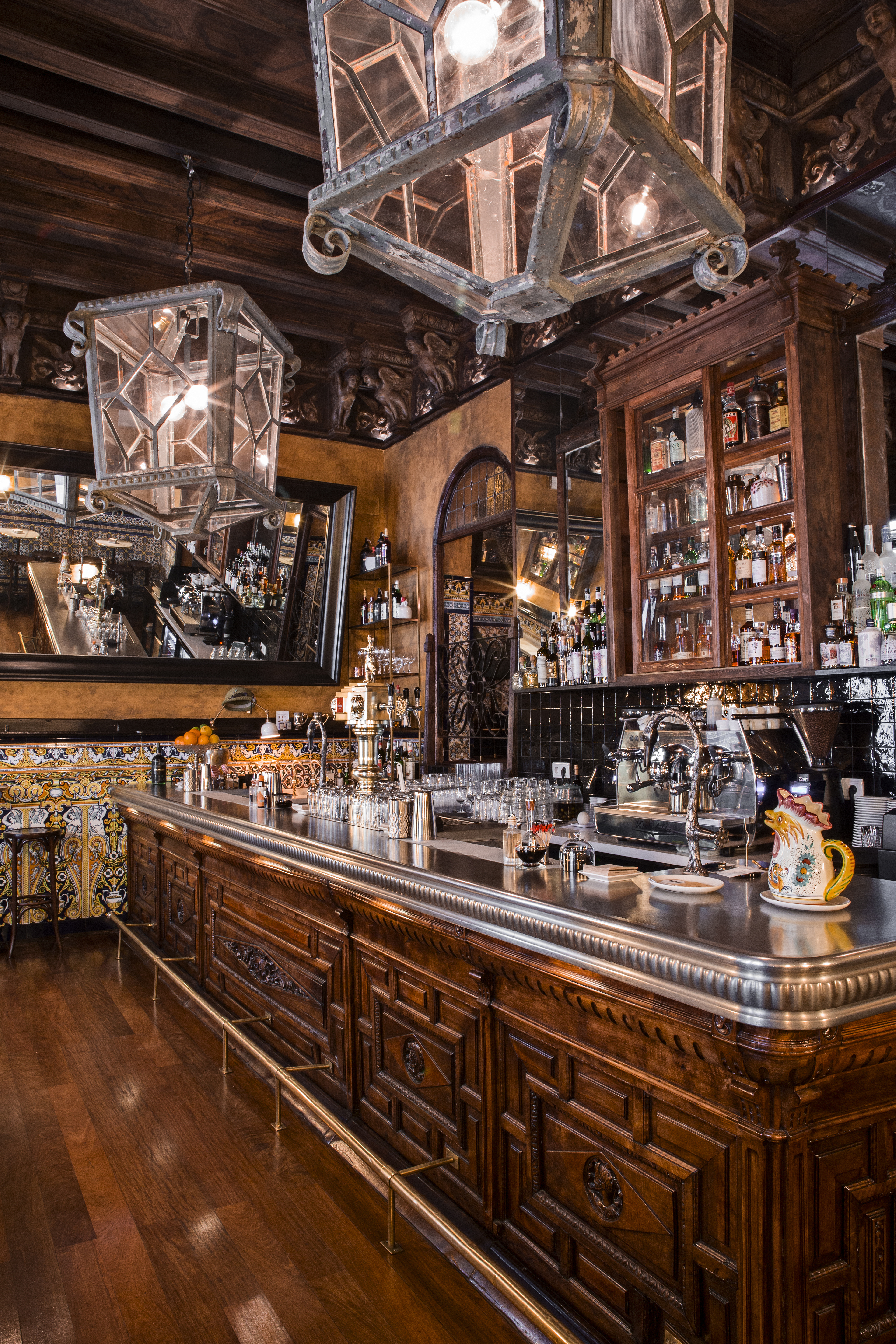 a bar with a mirror and bottles