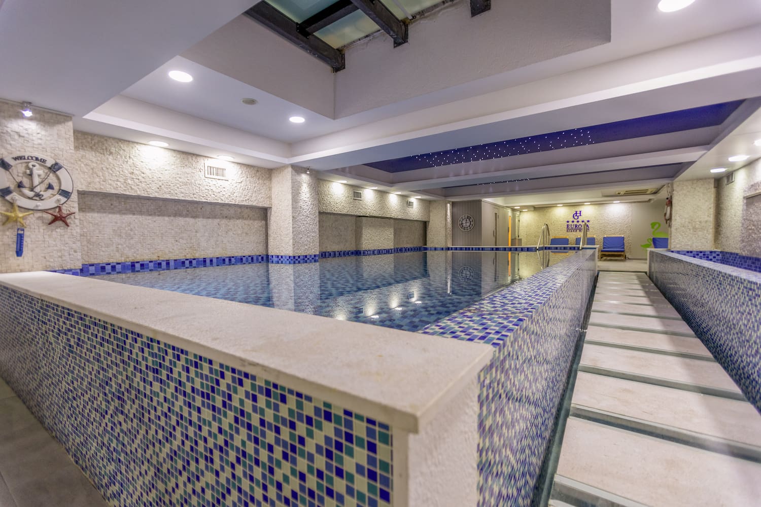 a indoor pool with a tile wall