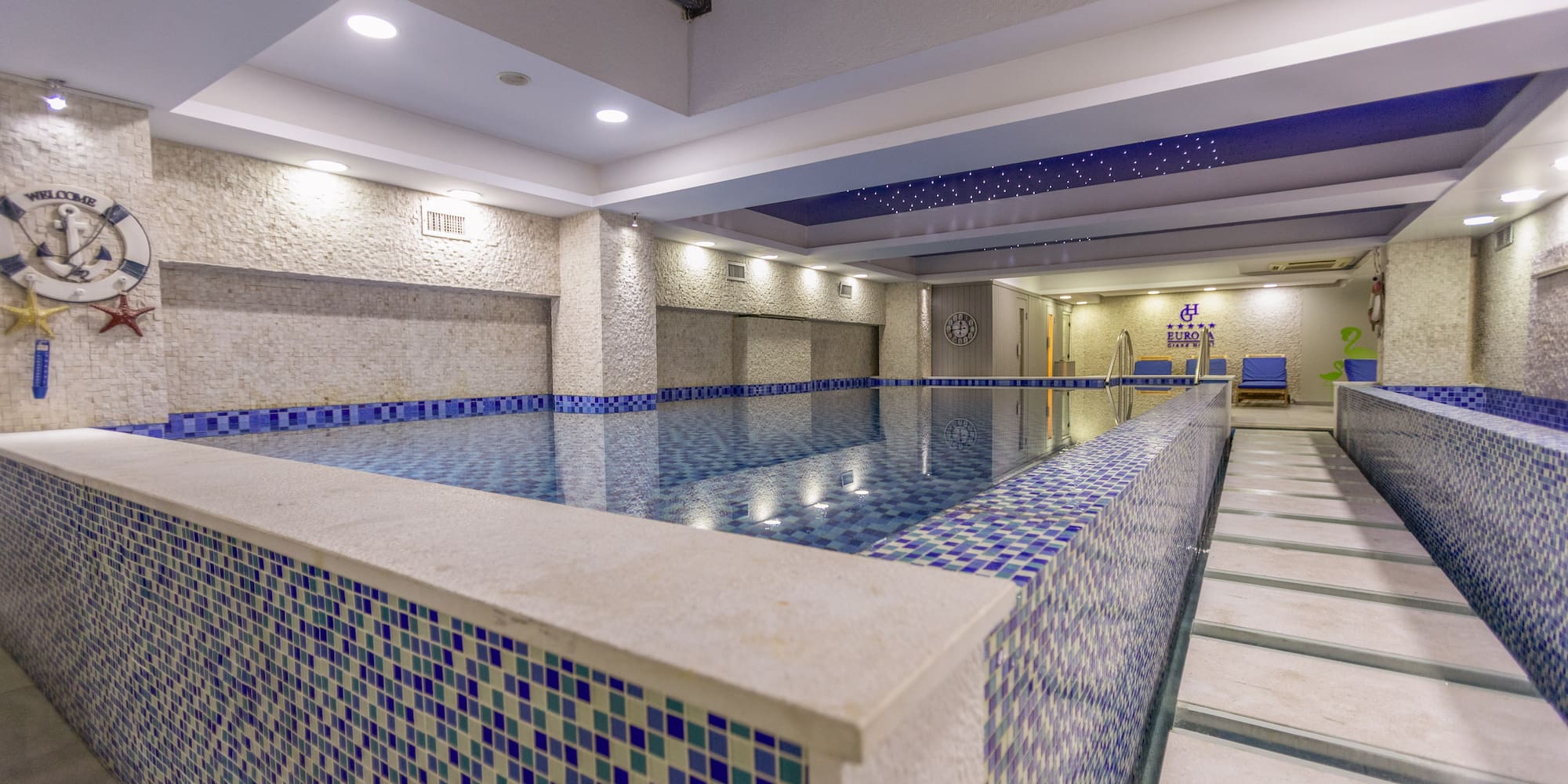 a indoor pool with a tile wall
